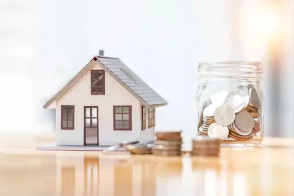 House model and coins representing real estate and home loan guidance in Temecula, California